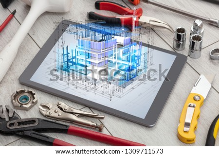 Tablet with construction tools and 3d house plan concept