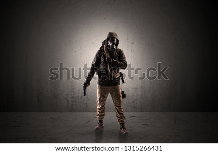 Bad agent in a dark room with arms on his hand and gas mask