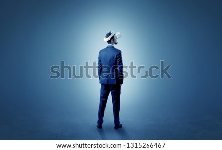 Businessman wearing vj glasse in an empty room with no wallpaper