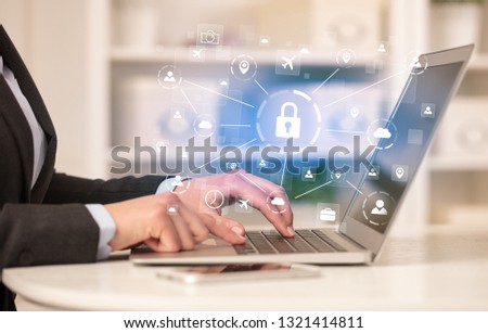Business woman below chest working on laptop in a cozy homey environment with secured connection concept