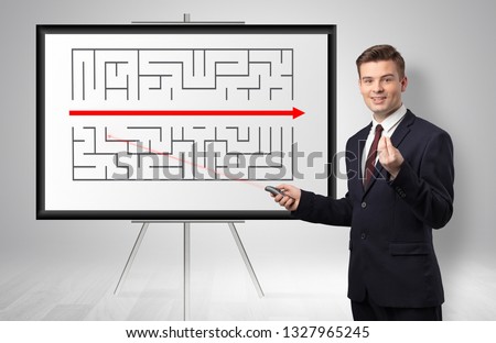 Handsome businessman with laser pointer  presenting potential exit from a labyrinth