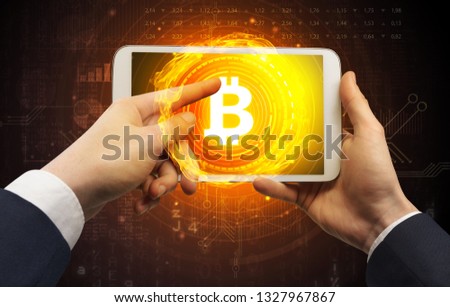 Elegant hand touching tablet with cryptocurrency concept