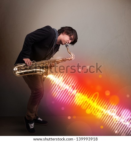 Attractive young man playing on saxophone with colorful sound waves
