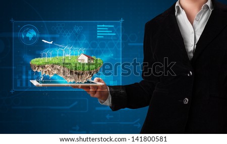 Young woman presenting a perfect ecology land with a house and windmills
