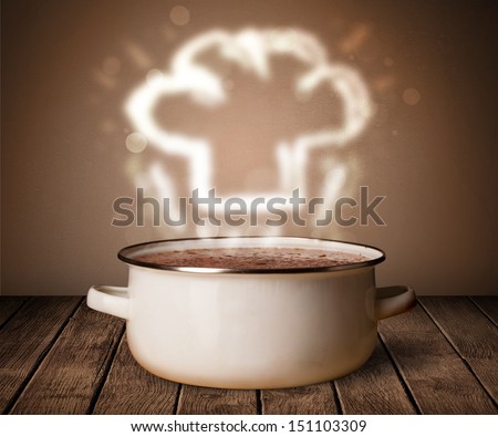 Chef hat coming out from cooking pot on wooden table