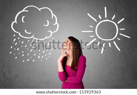 Pretty young woman standing and wondering between the sun and rain drawings