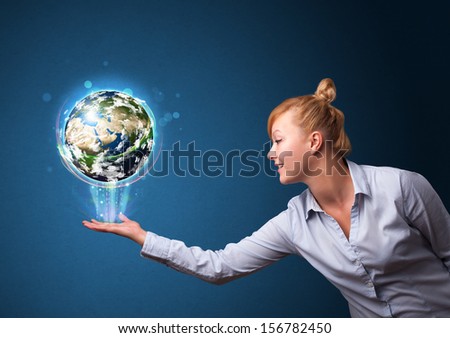 Young businesswoman holding in her hand a glowing earth globe, Elements of this image furnished by NASA