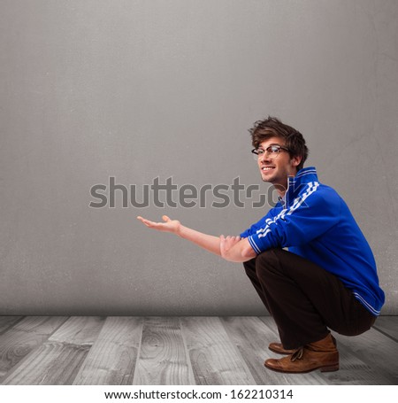 Handsome young man presenting an empty copy space