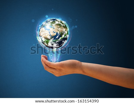 Young woman holding in her hand a glowing earth globe