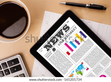 Workplace With Tablet Pc Showing Latest News And A Cup Of Coffee On A Wooden Work Table Close-Up