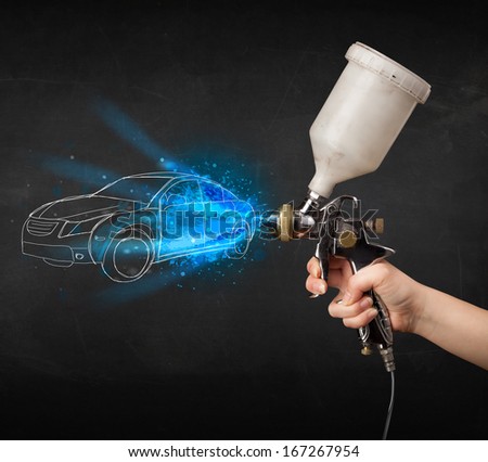 Worker with airbrush gun painting hand drawn white car lines