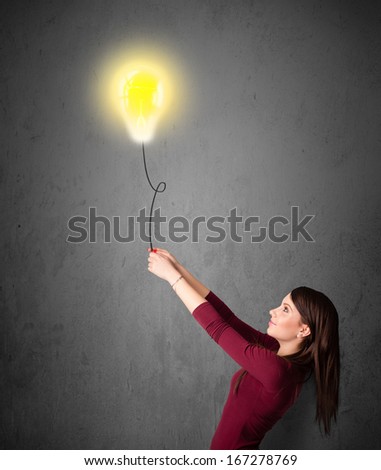 Young woman holding a lightbulb balloon