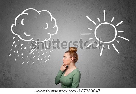 Pretty young woman standing and wondering between the sun and rain drawings