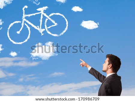 Young business man looking at bicycle clouds on blue sky