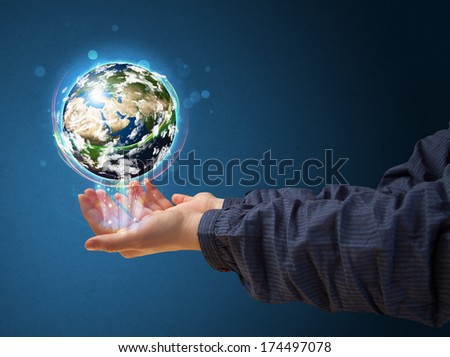 Young woman holding in her hand a glowing earth globe, Elements of this image furnished by NASA