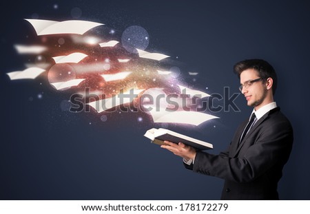 Young guy reading a book with flying sheets coming out of the book, magical reading concept