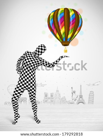 Funny man in full body suit holding colorful balloon, tourist attractions in background