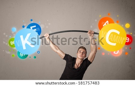 Strong muscular man lifting colorful vitamin weights