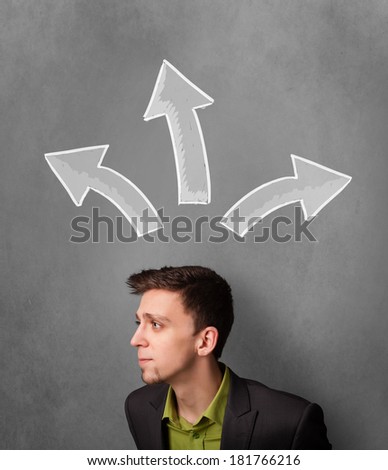Young businessman deciding with sketched arrows above his head