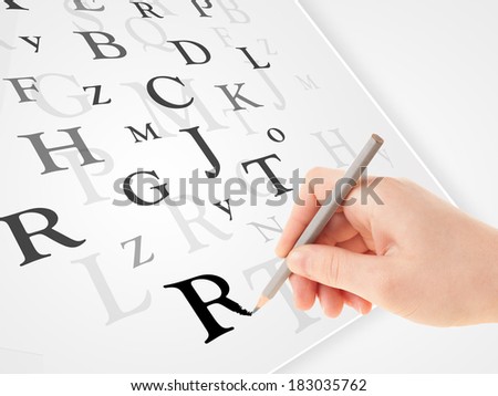 Human hand writing various letters on white plain paper