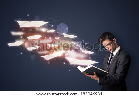 Young guy reading a book with flying sheets coming out of the book, magical reading concept