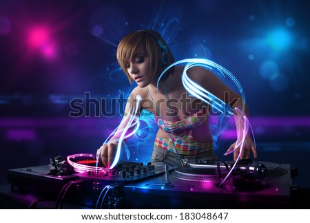 Beautiful disc jockey playing music with electro light effects and lights
