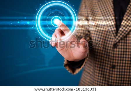 Young businessman pressing high tech type of modern buttons