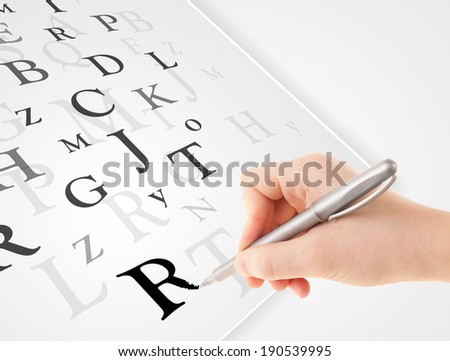Human hand writing various letters on white plain paper