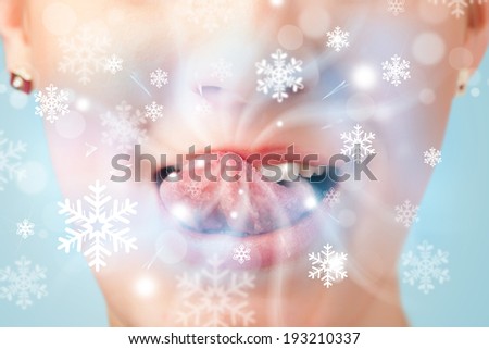 Pretty woman mouth blowing cold breeze close up