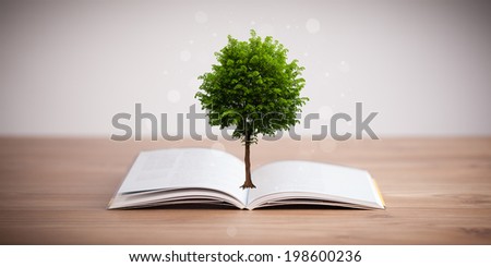 Tree growing from an open book, alternative recycling concept