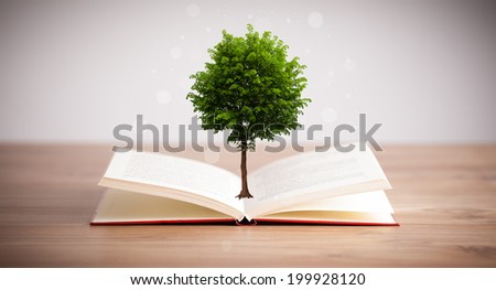 Tree growing from an open book, alternative recycling concept