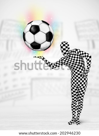 Funny man in full body suit holdig soccer ball