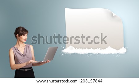 Attractive young woman holding a laptop and presenting modern copy space on clouds