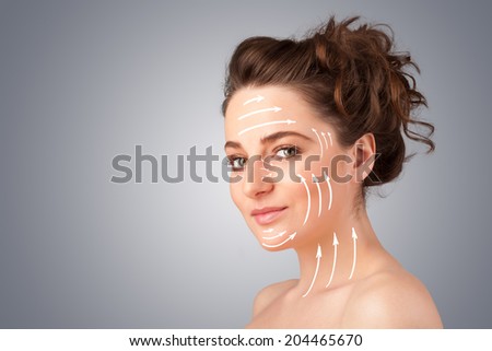 Beautiful girl with facial arrows on her skin on gradient background
