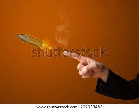 Gun shaped male hand with bullet coming out of it