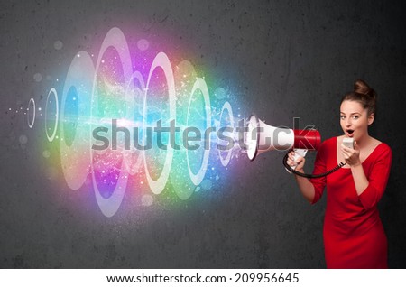 Cute young girl yells into a loudspeaker and colorful energy beam comes out