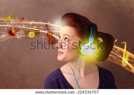 Pretty young woman with headphones listening to music, instruments concept