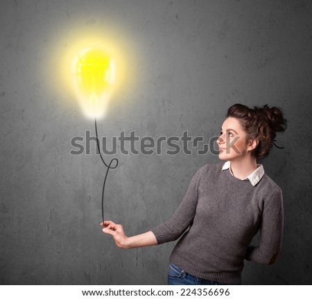 Young woman holding a lightbulb balloon