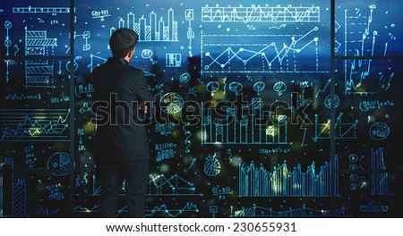 Businessman drawing business statistics on glass wall