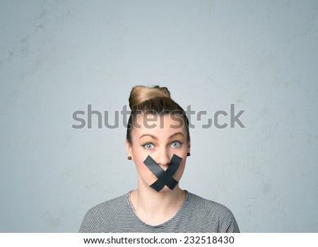 Young woman with taped mouth. Isolated on gray background