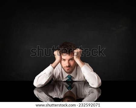 Depressed businessman sitting at a desk