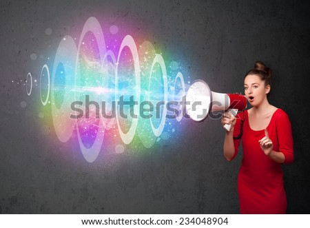 Cute young girl yells into a loudspeaker and colorful energy beam comes out