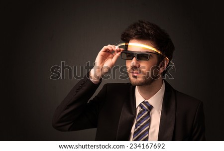 Handsome man looking with futuristic high tech glasses concept