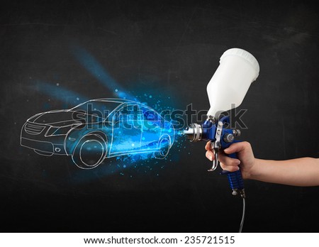Worker with airbrush gun painting hand drawn white car lines