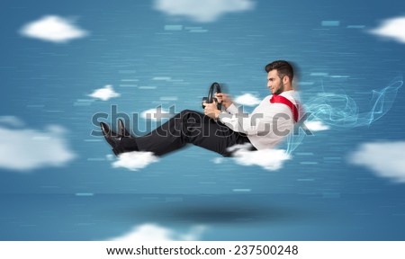 Funny racedriver young man driving between clouds concept on blue background