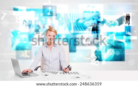 Business person at desk with modern blue tech images at background