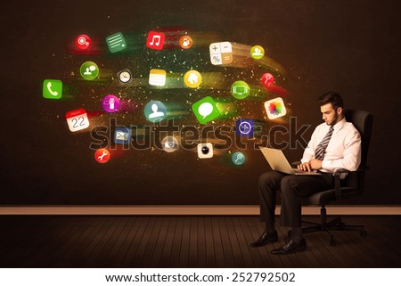 Business man sitting in office chair with tablet and colorful app icons concept on background