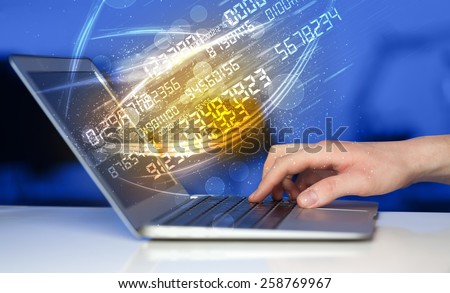 Man typing on modern notebook with future number technology data coming out