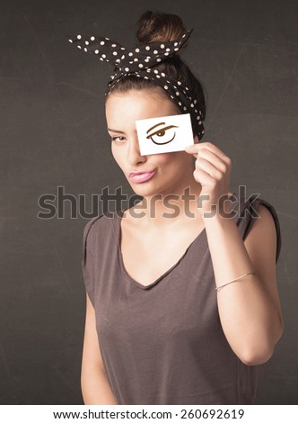 Young person holding paper with angry eye drawing concept