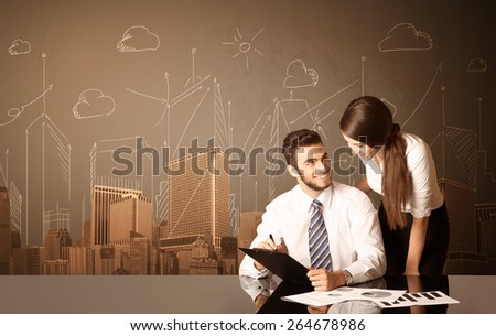 Business couple sitting at the black table with buildings and measurements on the background